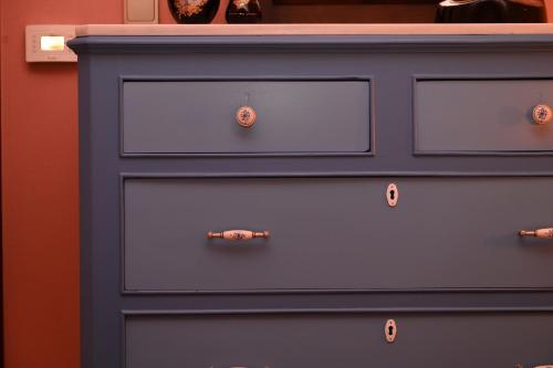 a blue dresser with buttons on it at PhiloXenia Traditional Apartments in Chios
