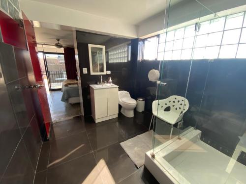 a bathroom with a glass shower and a toilet at Ica Adventures II in Ica