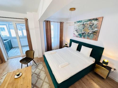 a bedroom with a bed and a chair in it at RHUM B02 - Liberty in Bucharest