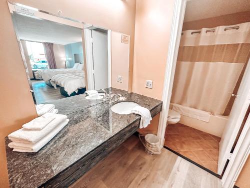 a bathroom with a sink and a mirror at Laker Inn in Jamestown