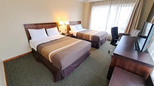 Una cama o camas en una habitación de Hotel Diego de Almagro Temuco