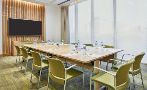 a conference room with a large table and chairs at Hilton Garden Inn Dubai, Mall Avenue in Dubai