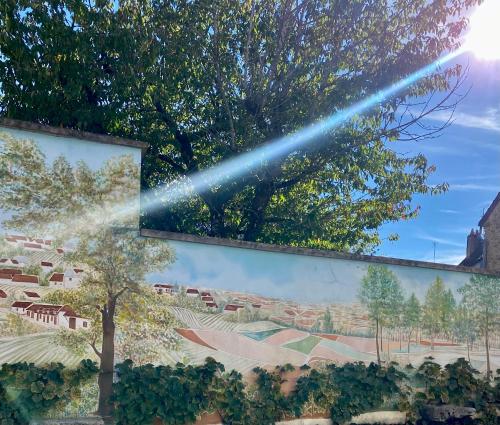 a beam of light shining on a wall with a mural at Domaine du Cellier de la Couronne in Sézanne
