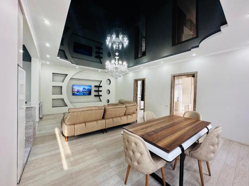 a dining room with a table and a couch at House in Tsikhisdziri in K'obulet'i