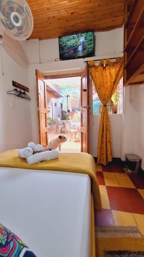 a bedroom with a dog standing on a bed at Hostal Colombian Gold in San Gil