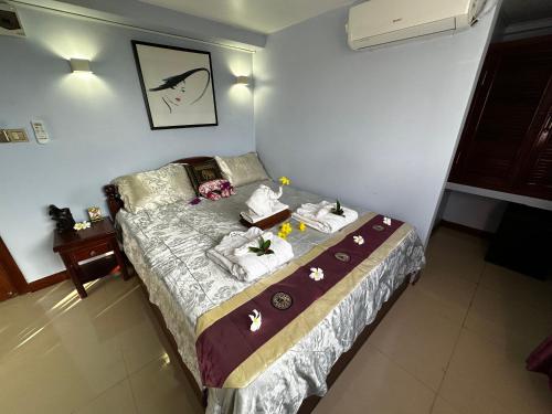 a bedroom with a bed with towels on it at Hawaii Lounge in Sihanoukville