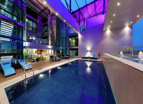a swimming pool in the middle of a building at Legend Hotel Lagos Airport, Curio Collection By Hilton in Lagos
