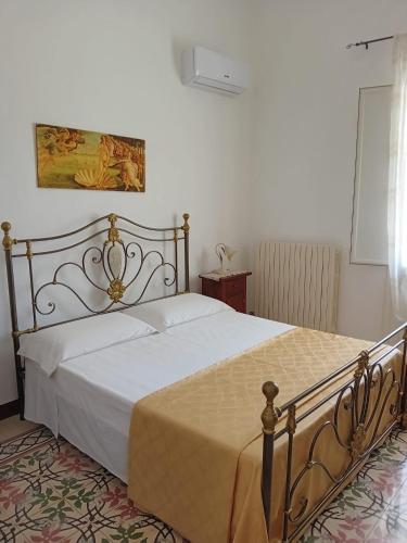 a bedroom with a large bed with white sheets at La chiccara del Bar Natale in Nardò