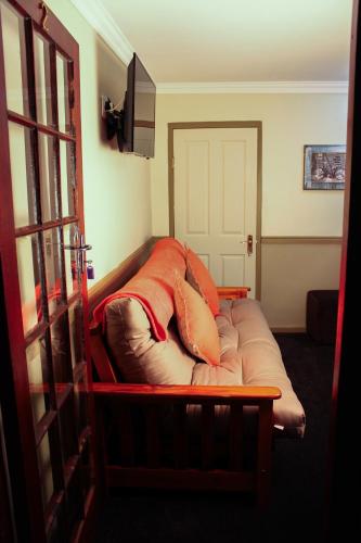 a couch with pillows on it in a room at Victoria Heights B&B in George