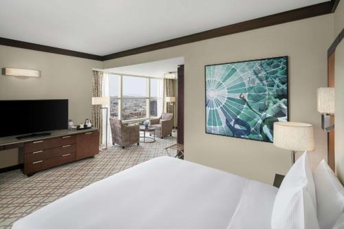 a hotel room with a bed and a flat screen tv at Doubletree By Hilton Jabal Omar Makkah in Makkah