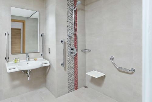 a bathroom with a sink and a shower at Hilton Garden Inn Muscat Al Khuwair in Muscat