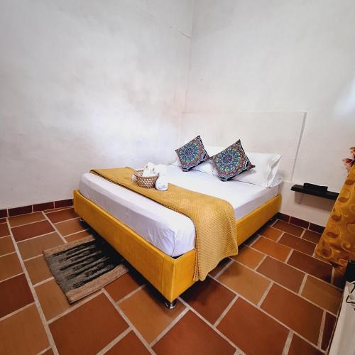 a bedroom with a bed in a room at Hostal Colombian Gold in San Gil