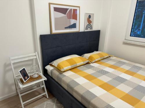 a bedroom with a bed and a side table at Novouređen stan u Vitezu in Vitez