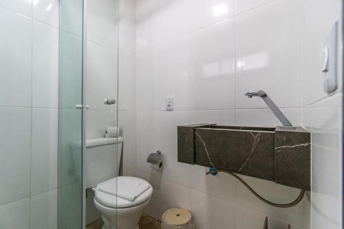 a bathroom with a toilet and a shower at Pousada Caminho do Mar in Bombinhas