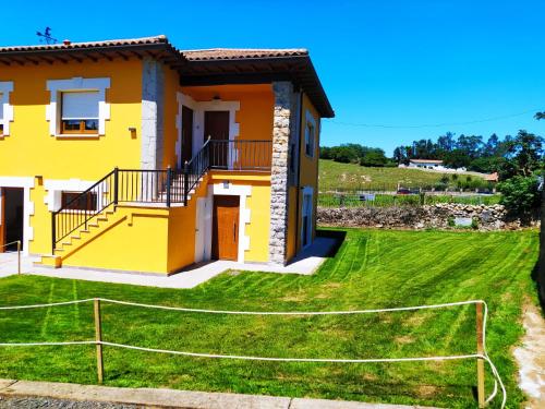 a house with a soccer field in front of it at APARTAMENTOS EL ROJU in Santillana del Mar