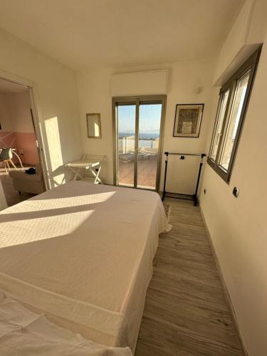 a bedroom with a bed and a view of the ocean at Giroloft in Cagliari