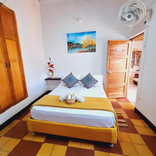 a bedroom with a bed with a stuffed animal on it at Hostal Colombian Gold in San Gil