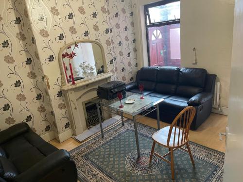 a living room with a couch and a table and a mirror at Quite Broad Rest 4 in Longford