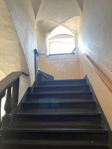 a set of stairs in a building with a window at House Gaudio 38 in Sanremo