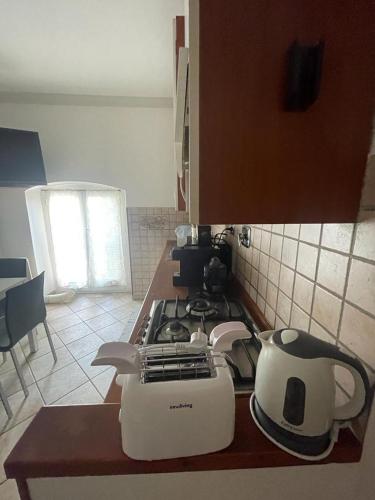 a kitchen with a stove and a toaster on a counter at House Gaudio 38 in Sanremo