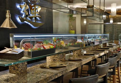 a restaurant with a long buffet line with food at Hilton Riyadh Hotel & Residences in Riyadh