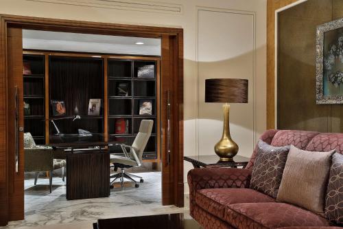 a living room with a couch and a desk at Hilton Riyadh Hotel & Residences in Riyadh