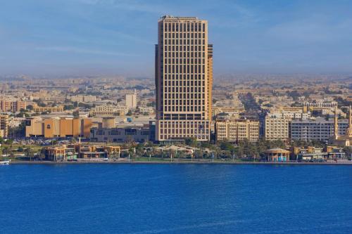 a view of a city with a tall building at DoubleTree by Hilton Sharjah Waterfront Hotel And Residences in Sharjah