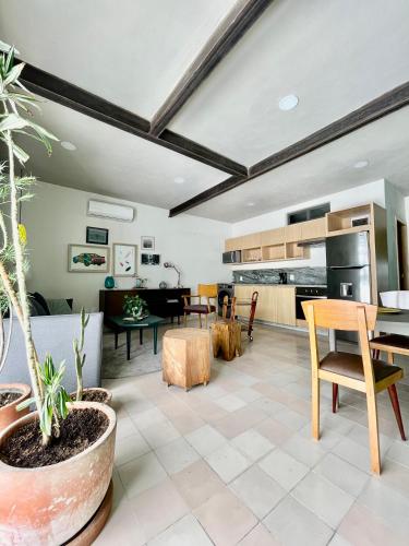 a kitchen and living room with a table and chairs at Casa San Fernando by Barrio México in Guadalajara