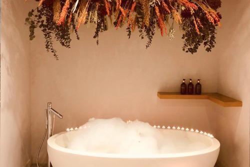 a bath tub with christmas lights in a bathroom at One Park Lane in Southwell