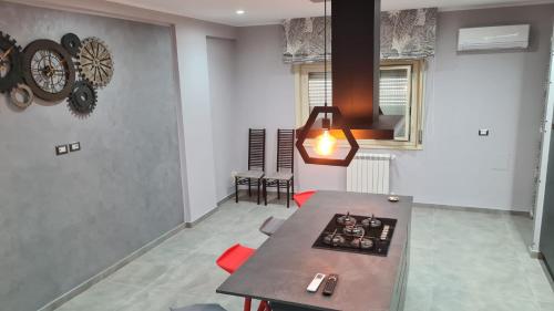 a kitchen with a table and a clock on the wall at CASA VENEZIANO in Messina