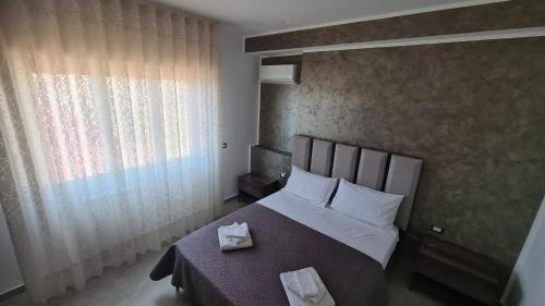 a bedroom with a bed and a window at CASA VENEZIANO in Messina