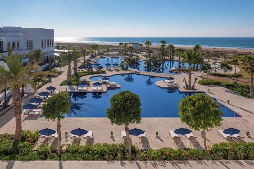 an aerial view of a resort with a pool and the beach at Hilton Tangier Al Houara Resort & Spa in Al Houara