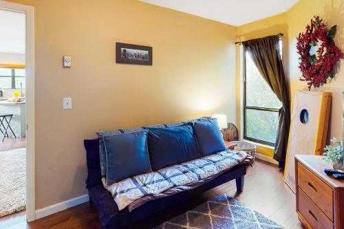 a living room with a blue couch and a window at Hillcrest Haven in Banner Elk