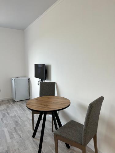 a table and two chairs in a room with a tv at Lake View in Borovoye