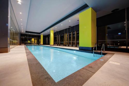 a swimming pool in the middle of a building at DoubleTree by Hilton Adana in Adana