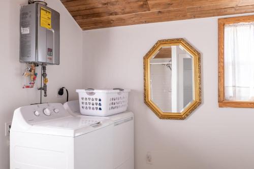 a bathroom with a washing machine and a mirror at Cozy Cabin near Ark! Adam and Eve's Retreat in Williamstown