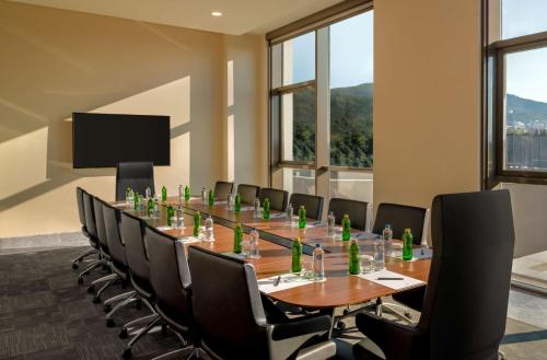 a conference room with a long table and chairs at DoubleTree by Hilton Manisa in Manisa