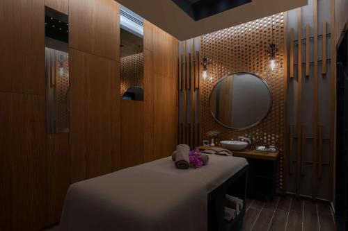 a bathroom with a sink and a mirror at DoubleTree by Hilton Manisa in Manisa