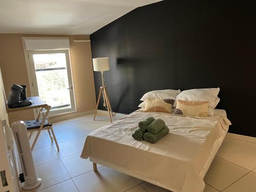 a bedroom with a large bed with a black wall at T2 Prado Plage / Vélodrome in Marseille