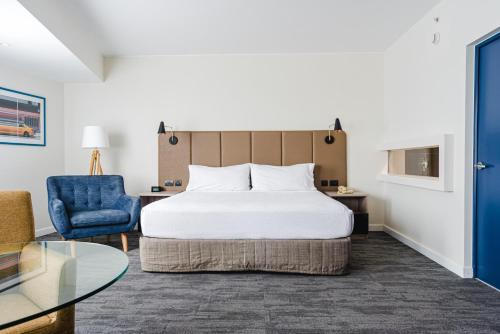 a hotel room with a bed and a blue chair at Crowne Plaza Lima by IHG in Lima