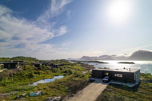 a house on the shore of a body of water at NEW! Lofoten Luxury Home near Henningsvaer in Lyngværet