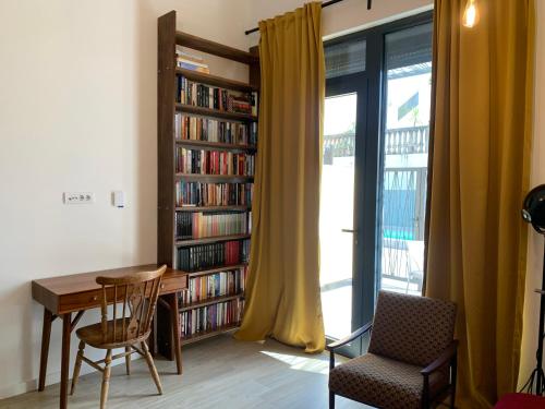 a room with a table and a book shelf with books at Sunny studio apartment Chiara in Tivat