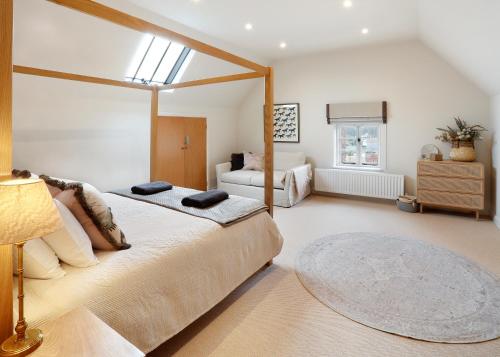 a bedroom with a large bed and a window at The Old School House in Evesham