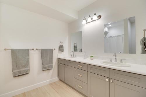 a bathroom with two sinks and a large mirror at Mountain and Lake View Rexford Estate on 28 Acres! in Rexford