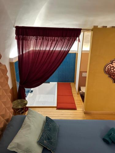 una camera con letto e tenda rossa di Sea Riad a Molfetta