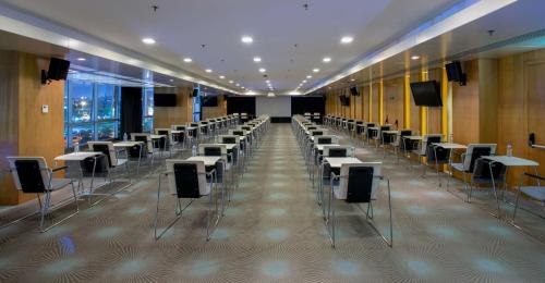 a room with rows of tables and chairs at DoubleTree By Hilton Istanbul - Moda in Istanbul