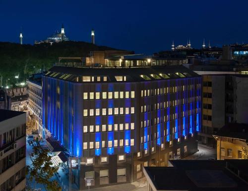 a large building with blue lights on it at night at DoubleTree by Hilton Istanbul - Sirkeci in Istanbul