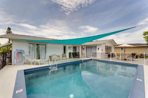 a swimming pool in front of a house at Heated Pool Canal-Front Rotonda West Retreat in Rotunda-West
