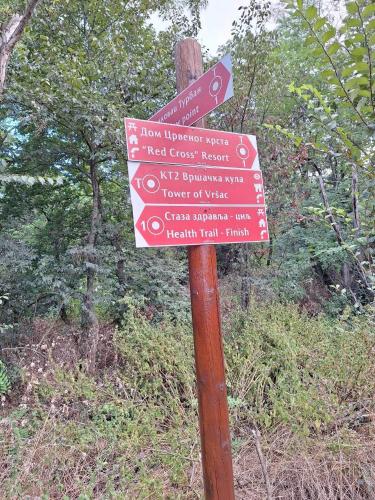 a sign on a wooden pole with signs on it at Vila Vera in Vršac