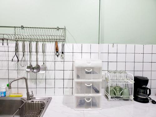 a kitchen with a sink and utensils at Nimman home 4 bedroom near One Nimman in Chiang Mai